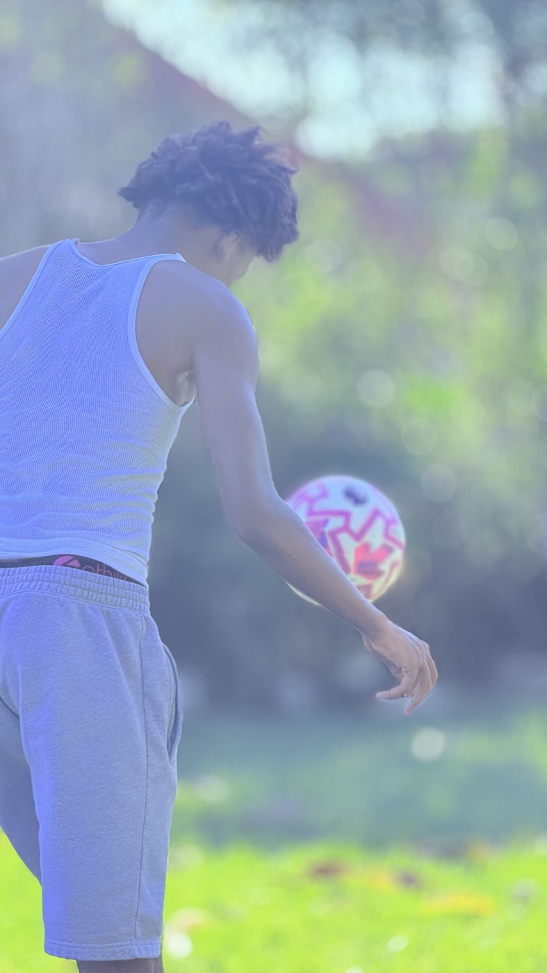 Chaz L. Grey juggling a soccer ball outdoors in a casual training moment