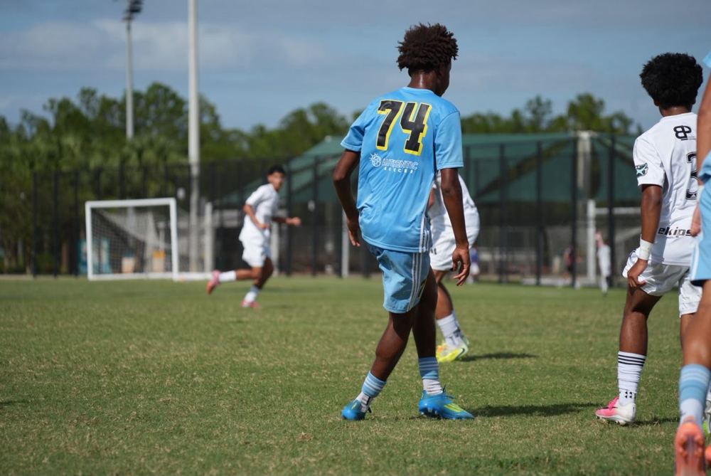 Chaz L. Grey, #74 seen from behind, moving into attack