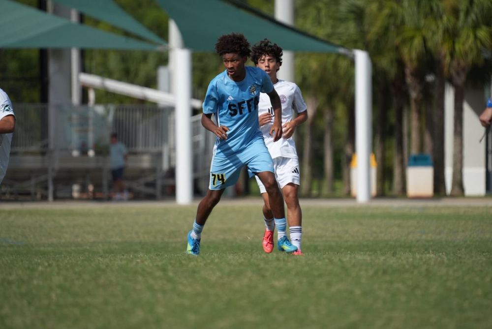 Chaz L. Grey shielding the ball from a defender